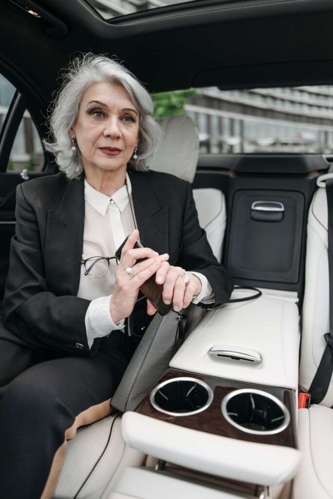 luxury airport transfer NYC sedan waiting at the JFK arrivals curb