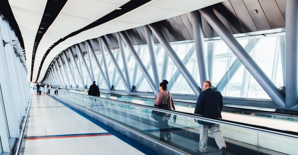 People walking through an airport with luggage.