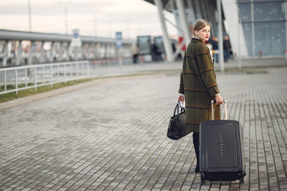 airport transportation, a traveler pulling a suitcase toward the terminal curb