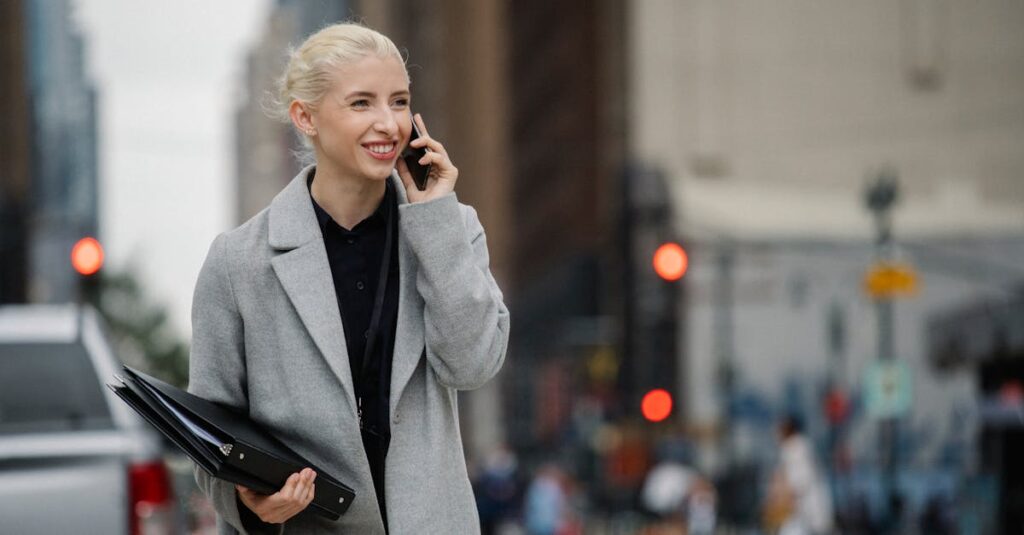 Traveler walking on a Manhattan street while talking on the phone before a JFK ride