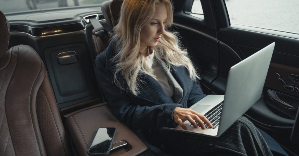 Luxury sedan rear seat Luxury sedan for executives NYC with a rear seat set for a laptop and a carry-on