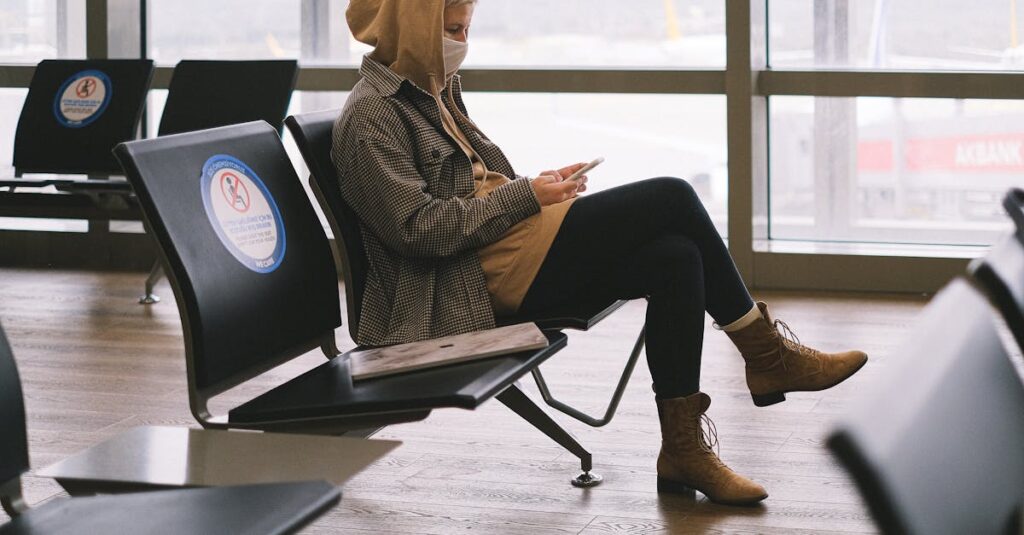 a woman sitting in an airport waiting area before her airport transportation pickup